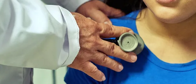 A doctor examining a young patient with a stethoscope